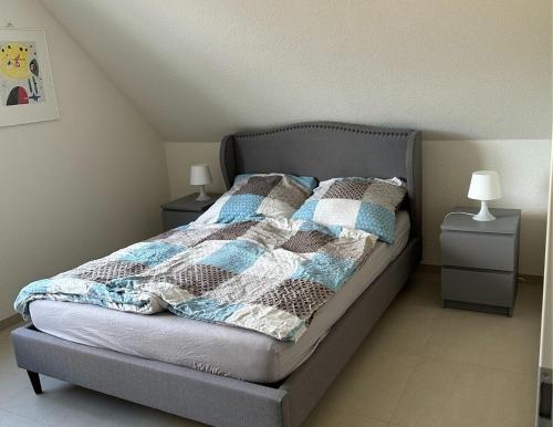 a bedroom with a bed with two night stands and two lamps at Ferienwohnung Linus OG 95172 in Rhauderfehn
