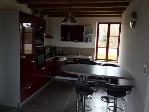 a kitchen with a table and some chairs in it at Gîte les petits cris 