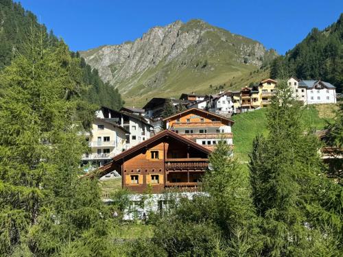 a group of buildings on a mountain with trees at Casa Carinthia in Samnaun