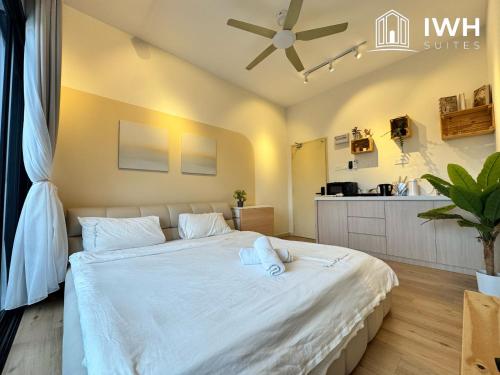 a bedroom with a large bed with white sheets at Ipoh Horizon Skypool Town Suites 4-11pax by IWH Suites in Ipoh