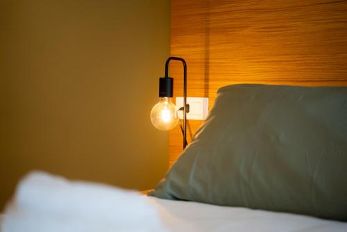 a bedroom with a bed with a lamp on it at Locanda 19 al paradiso in Mirano