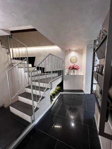 a staircase in a house with black flooring at Hotel Vespasiano in Rome
