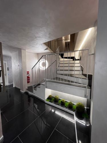 a kitchen with a spiral staircase in a building at Hotel Vespasiano in Rome