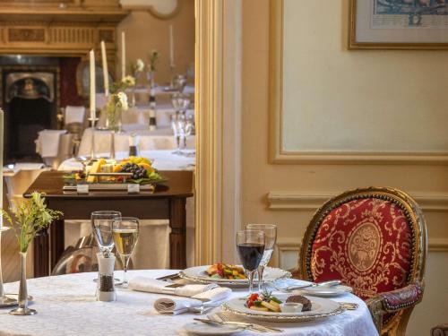 a table with plates of food and wine glasses at Pavillon Winter Luxor in Luxor