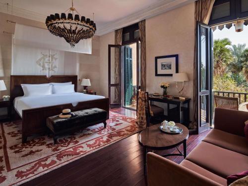 a bedroom with a bed and a living room at Sofitel Legend Old Cataract in Aswan