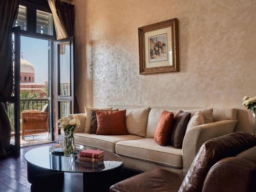 a living room with a couch and a table at Sofitel Legend Old Cataract in Aswan