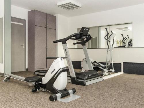a gym with a treadmill and a elliptical machine at ibis Falaise Coeur de Normandie in Falaise
