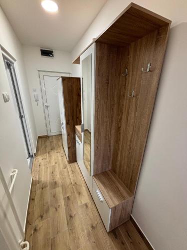 a hallway with wooden walls and wooden floors at Sweet home in Bor