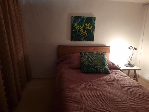 a bedroom with a bed with a green pillow on it at Λαγκάδι Μάνης in Koíta