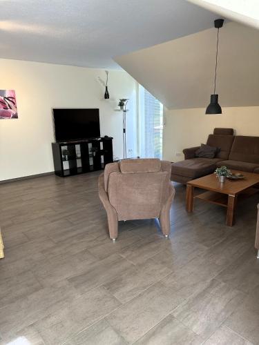 a living room with a couch and a table at Ferienwohnung Jasi, OG 95174 in Rhauderfehn