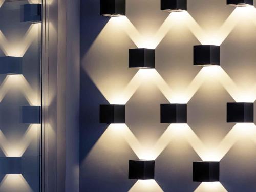 a wall with lights on a wall at Mercure München am Olympiapark in Munich