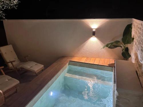 a swimming pool in the middle of a house at night at Maison de charme à Mérindol + Jardin in Mérindol