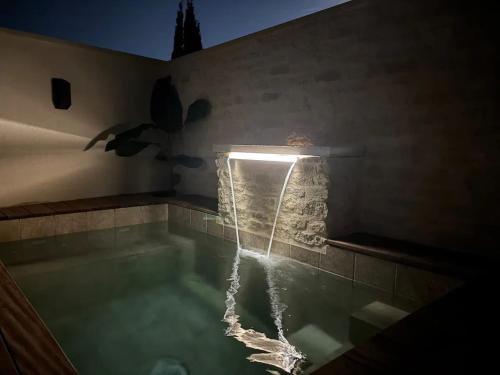 a swimming pool with a light in the middle at Maison de charme à Mérindol + Jardin in Mérindol