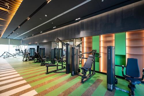 a gym with treadmills and cardio equipment in a room at 2BR Luxe Haven - Chic Al Reem Escape in Abu Dhabi