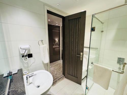 a bathroom with a toilet and a glass shower at Taj Executive Hotel Islamabad - Luxury Stays Opposite Jinnah Super F-7 in Islamabad