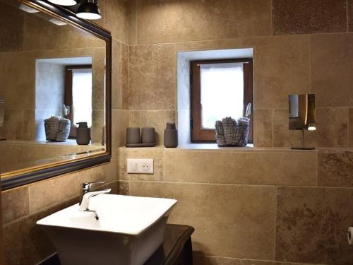 a bathroom with a sink and a mirror at Charmante maison périgourdine avec piscine et parking à Calés - FR-1-824-20 in Calès