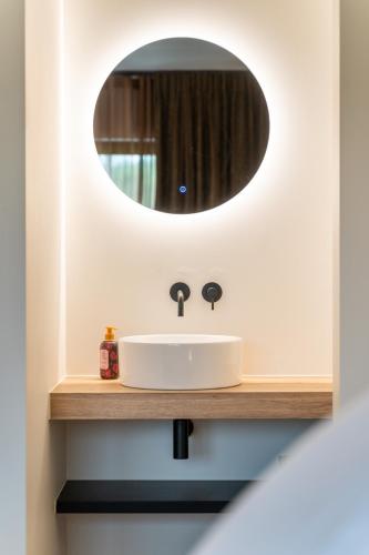 a bathroom with a sink and a mirror at Villa Weidezicht in Heusden - Zolder