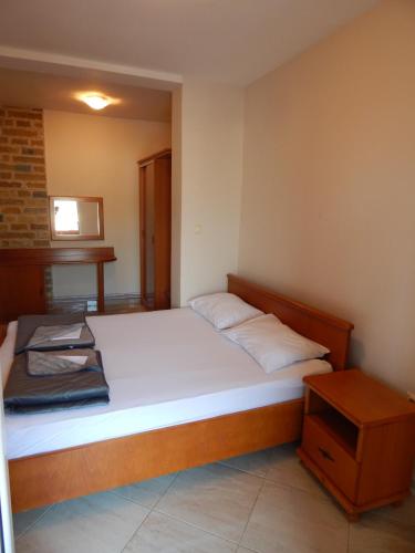 a small bedroom with a bed and a table at Contessa Apartments in Budva