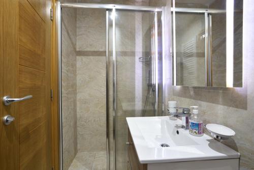 a bathroom with a sink and a shower at Vila Mina in Zlatibor