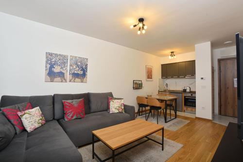 a living room with a couch and a table at Vila Mina in Zlatibor