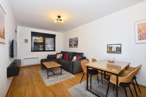 a living room with a couch and a table at Vila Mina in Zlatibor