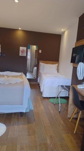 Una cama o camas en una habitación de Flores da Praça