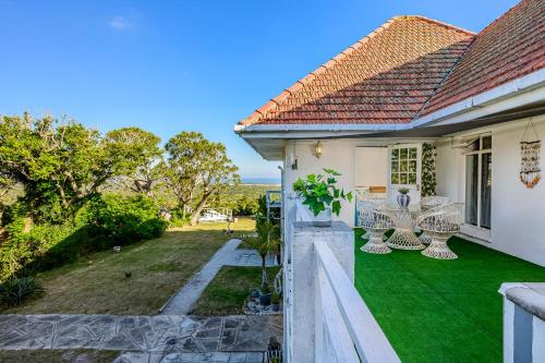 a view from the balcony of a house with green grass at 302 On Old Sea View Road Chelsea in Port Elizabeth