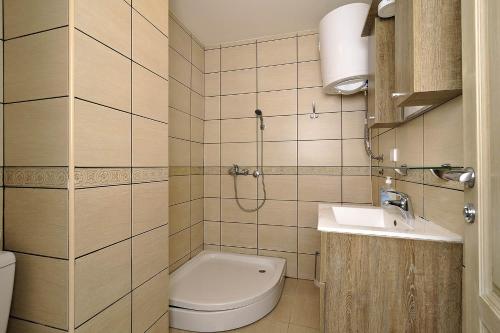 a small bathroom with a toilet and a sink at Vila Mina in Zlatibor