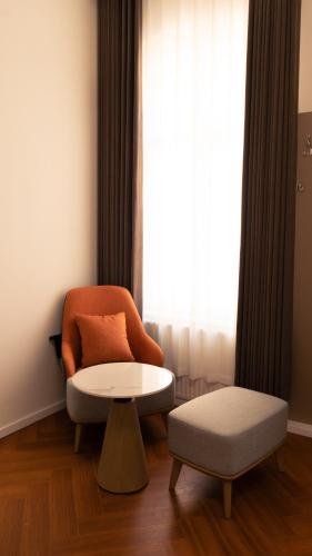 a living room with a chair and a table at Elias Residence Vienna in Vienna