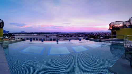 a large swimming pool on the roof of a building at 1969 D'Kelly Hotel in Ipoh