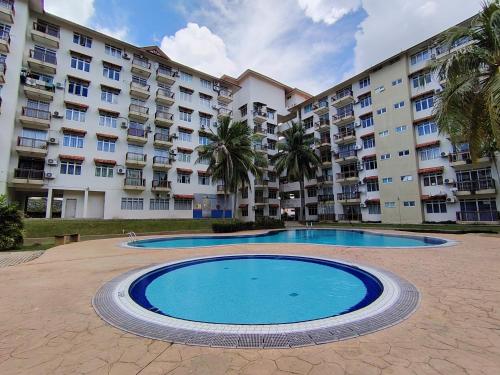 a large apartment building with a large swimming pool at Iris 2 Bedroom Pool View Balcony in Kampong Tanah Merah