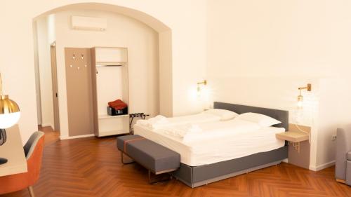 a bedroom with a bed and a chair in it at Elias Residence Vienna in Vienna