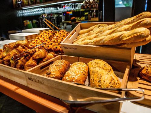 a bunch of different types of bread and pastries at ibis Paris Bercy Village in Paris