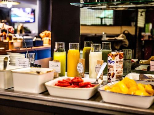 a buffet with fruit and juice on a table at ibis Paris Bercy Village in Paris