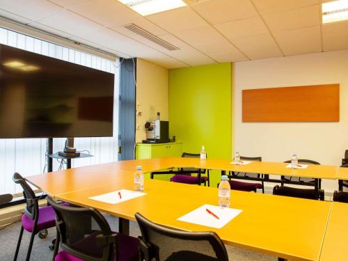 a conference room with tables and chairs with water bottles on them at ibis Paris Bercy Village in Paris