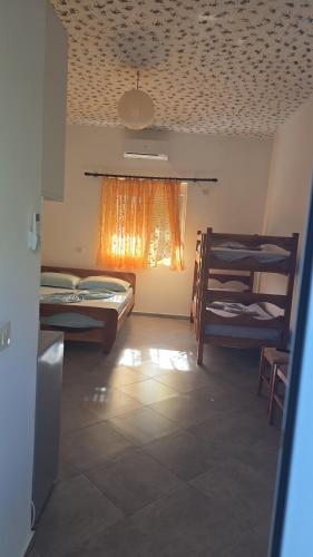a room with two bunk beds and a window at Toska homes in Mullini i Danit