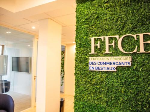 a green wall with a sign on it at ibis Paris Bercy Village in Paris
