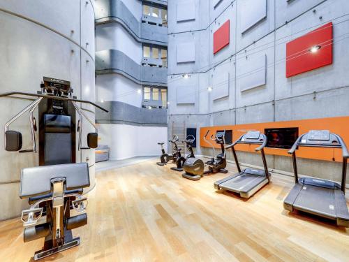 a gym with several treadmills and exercise bikes at Novotel Paris Gare De Lyon in Paris