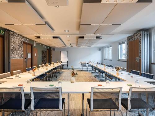 a large room with tables and chairs in a classroom at Novotel Paris Gare De Lyon in Paris