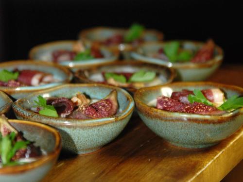 a group of bowls of food on a wooden table at Novotel Paris Gare De Lyon in Paris