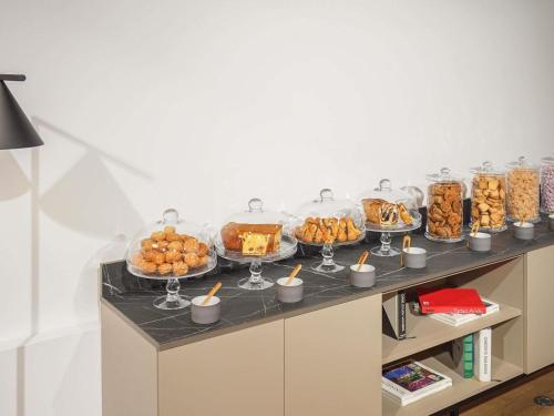 a buffet with many trays of food on a table at Novotel Paris Gare De Lyon in Paris