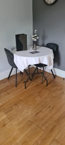 a table with a white table cloth on it with chairs at The Finch Hatton Arms in Sleaford