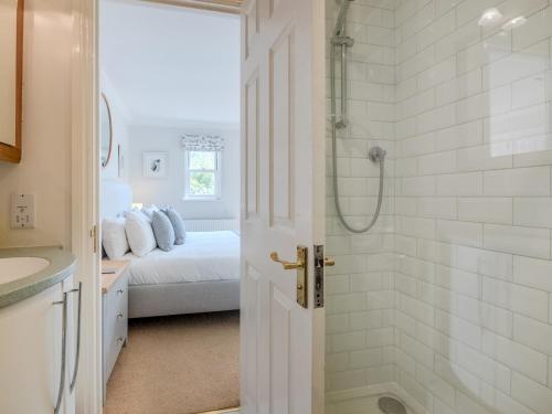 a white bathroom with a shower and a bed at Pass the Keys Central Mews house with parking in Bath