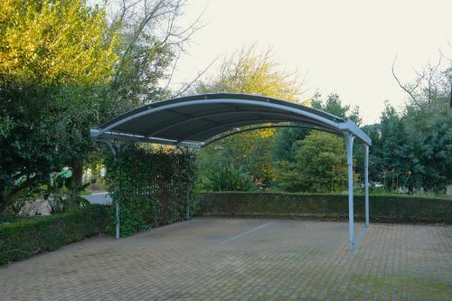 a black canopy in a brick yard with trees at Modern Family Golf Lodge in Winelands Paradise in Paarl