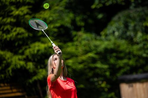 a woman hitting a tennis ball with a racket at Horská chata 049 Prkenný Důl, Žacléř, Krkonoše in Žacléř