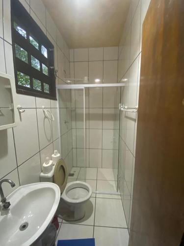 a bathroom with a toilet and a sink at Pousada Figueira in Trindade