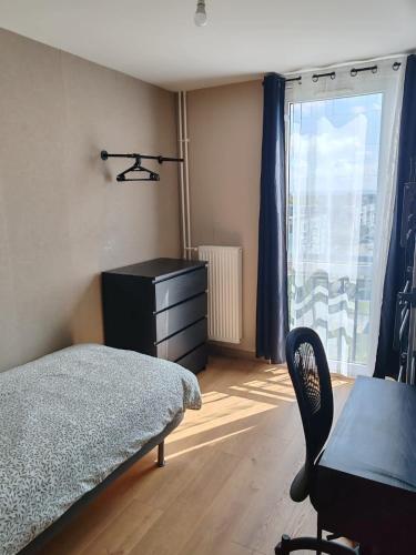 a bedroom with a bed and a desk and a window at Altitude Intérieure in Le Perrey