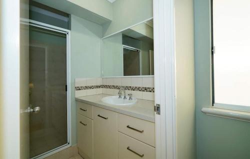 a bathroom with a sink and a shower at 40 Modern & Chic Apt In East Perth in Perth