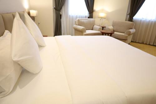 a large white bed in a hotel room at Best Day Hotel and Resorts المحمدية in Jeddah