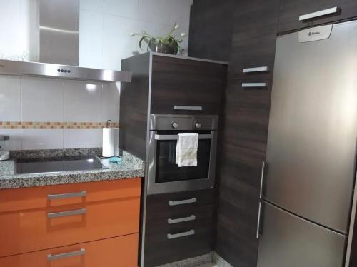 a kitchen with a stainless steel refrigerator and a stove at Cozy apartment in Orense of 45 m² with parking in Ourense